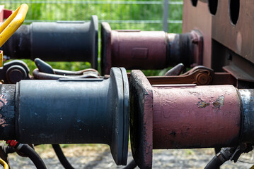 Chain coupler connecting freight wagons, large wagon buffers visible.
