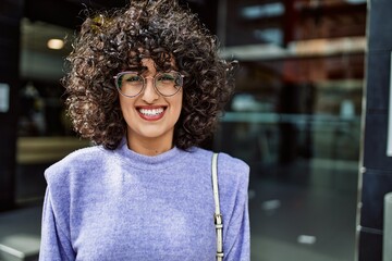 Young middle east woman smiling confident wearing glasses at street