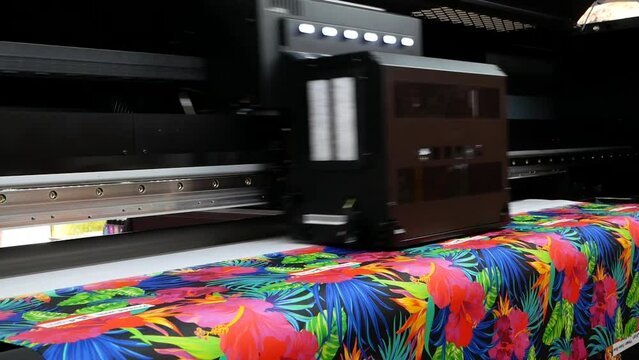 The plotter prints on a textile fabric. Production process in a manufacturing company.