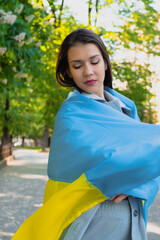 Woman with flag of Ukraine outdoor. Russia and Ukraine conflict