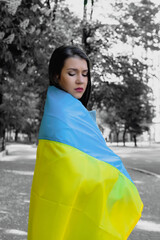 Portrait of woman with Ukrainian flag. Stand with Ukraine