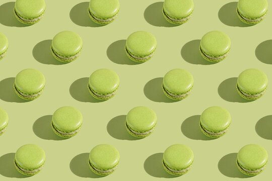 Hard Light Pattern Of A Green Macaron Pastry Photographed On Light Green Surface