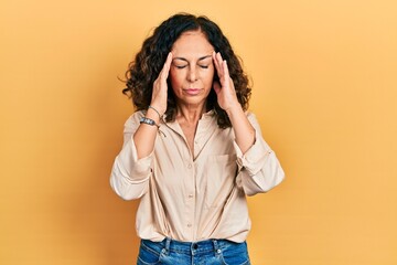 Middle age hispanic woman wearing casual clothes with hand on head for pain in head because stress. suffering migraine.