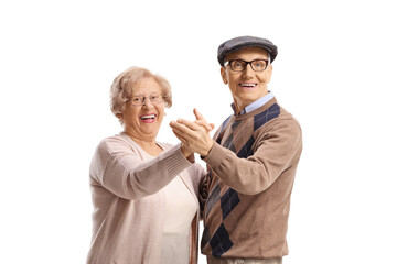 Happy elderly man and woman dancing tango