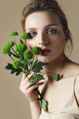 Portrait Young Woman Natural Makeup Woman Holding Green Flower Hand Natural cosmetics. Cosmetology and rejuvenation.
