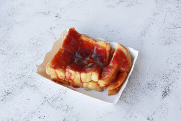 Sweet toast with blueberry jam in paper box on stone background, dessert homemade.