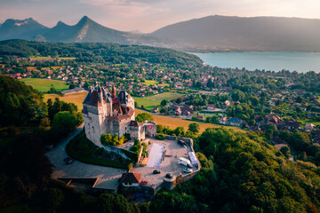 Aerial shot of the Castle of Menthon-Saint-Bernard overlooking the town and lake in Annecy, France