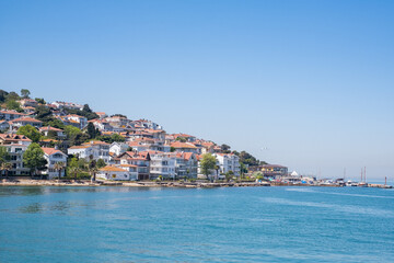 Naklejka na ściany i meble view on a small village on an island with blue water in fron (Istanbul)