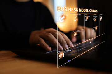 Businessman using laptops to plan his business by tools of business model canvas, key partner...
