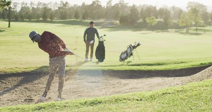 Video of diverse male friends playing golf on golf field