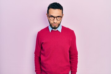 Hispanic man with beard wearing business shirt and glasses skeptic and nervous, frowning upset because of problem. negative person.