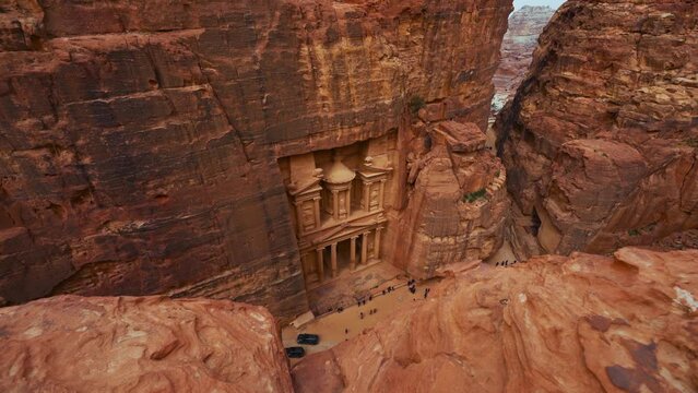 The Treasury Khaznet at Petra, historic UNESCO heritage site carved into sandstone in Jordan seen from a viewpoint above. Famous Indiana Jones Last Crusade filming location and tourist destination.