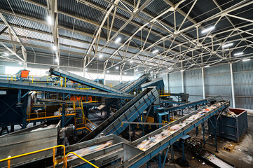 Large production line with conveyors carrying trash at plant