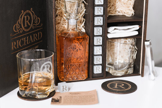 set for whiskey in a wooden box with engraving on a white background