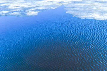 Ripples on the surface of the water. Ice melts in the spring on the lake