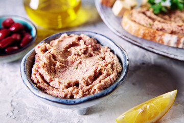 Homemade kidney bean liverwurst pate in a small ceramic bowl placed on a table