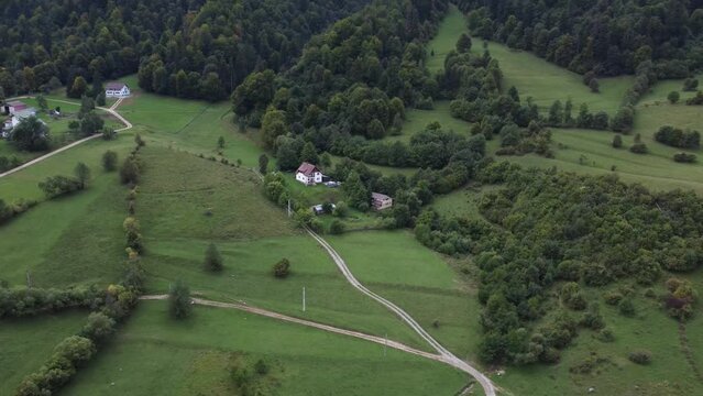 Romanian house in aerial drone shot. Small typical home close to the mountain
