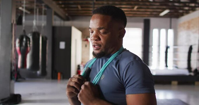 Video of fit afrcan american man posing at gym