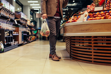 Fototapeta premium Customer choosing fruits at supermarket