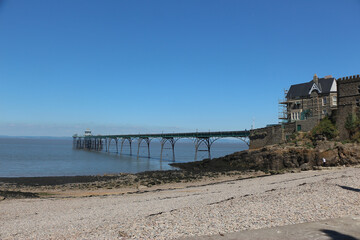Clevedon pier putside of Bristol in South West England under the scorching sun on a clear summers day as the river servern lazily flows by