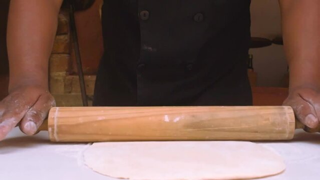Wood-fired pizza. Pizza preparation in restaurant. Ketchup. kneading pizza. kiln. placing ingredients, tomato, cheese, mushroom, black olive, pepperoni, ham and peppers.