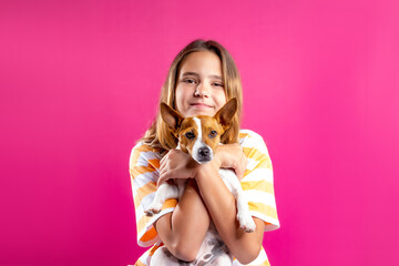 Happy girl with puppy as a concept of pet care, dog shelters, dog hotels, dog training and...