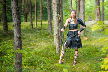 mediaeval female mosstrooper wearing leather skirt, vambrace, plastron and brassart with heavy...
