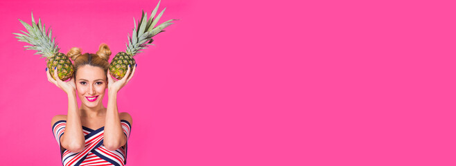 Fototapeta premium Fashion portrait funny woman with pineapple banner over pink background with copy space and place for advertising