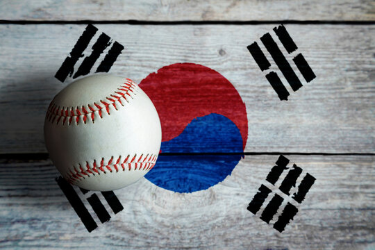 Leather Baseball On Rustic Wooden Background Painted With South Korean Flag. South Korea Is One Of The World's Top Baseball Nations.