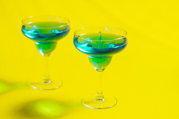 Bartender pouring Blue Lagoon  curacao syrup mixed with vodka and lemonade cocktail from a shaker
