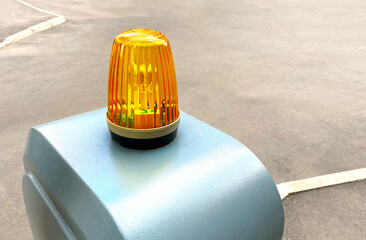 Close up of warning yellow flashing beacon at the entrance to the territory. Danger, attention or...