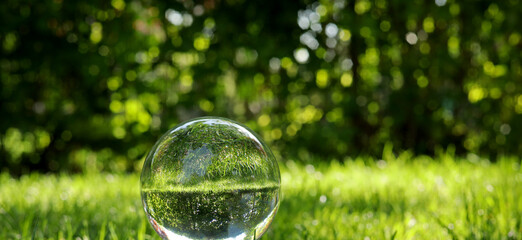 landscape with glass lens ball in the garden - obrazy, fototapety, plakaty