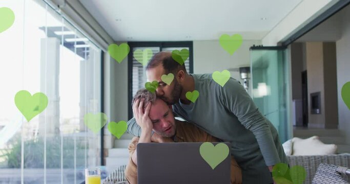 Animation of heart icons over diverse gay couple embracing