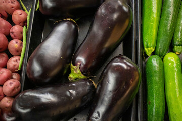 Retail store fresh produce egg plant and cucumbers