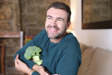 Excited man holding a broccoli