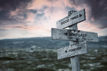 good times dont last forever text quote caption on wooden signpost outdoors in nature. Stock sign...