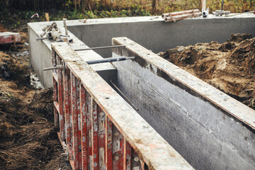 Concrete foundation with reinforcement and metal slab. Formwork for foundation. Construction site,...