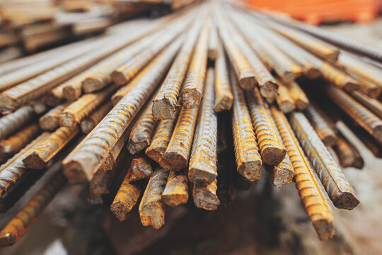 Reinforcement rods at construction site. Steel rebar close up. Rusty steel reinforcement bars for concrete. Process of house building. Industrial