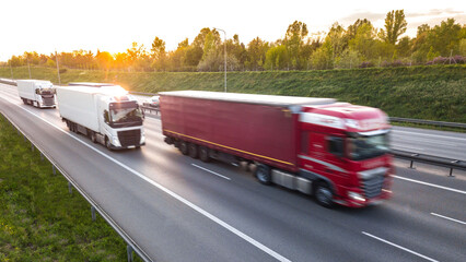 Big freight trucks on a highway with motion blur effect