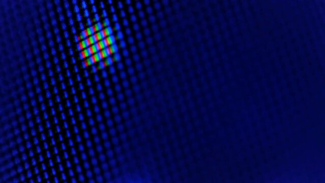Bright abstract dots moving to the top on a background of blue pixels, macro soft focus