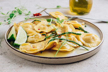 Italian cheese ravioli with roasted asparagus in herbed lemon butter sauce