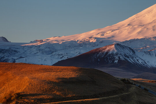 Horizontal landscape overlooking the valley of Mount Elbrus. Dawn of the sun, early morning, Snowy slope of the mountain.