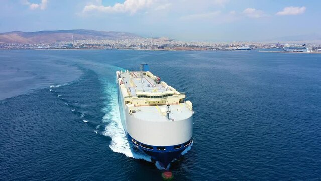 Aerial drone video of huge car carrier ship RO-RO (Roll on Roll off) cruising in Mediterranean deep blue open ocean sea