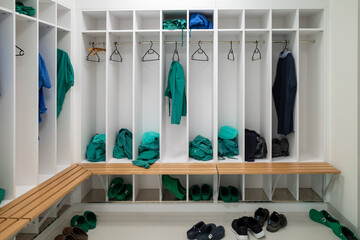 green and blue surgical gowns hang in an operating room in the hospital