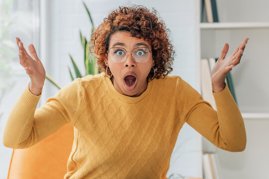 woman at home surprised or with a gesture of astonishment