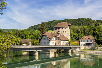 Fototapeta na wymiar Hohentengen am Rhein, Germany - 15. May 2022: The medieval fort Rotwasserstelz and the custom house Roetteln at the bridge connecting Switzerland and Germany.