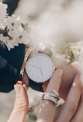 Beautiful stylish elegant white watch on woman hand. Close-up photo.