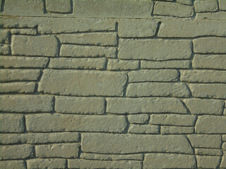 Background image with architectural pattern of rock bricks of irregular shapes and sizes.