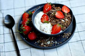 Delicious healthy breakfast or dessert with strawberries, white yogurt and chocolate granola. Healthly food. Strawberry dessert. Breakfast bowl.