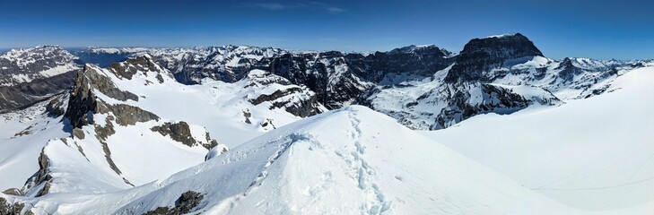 Ski mountaineering on the Bocktschingel in Glarus Uri. Winter mountain landscape with a view of the snowy glaciers.